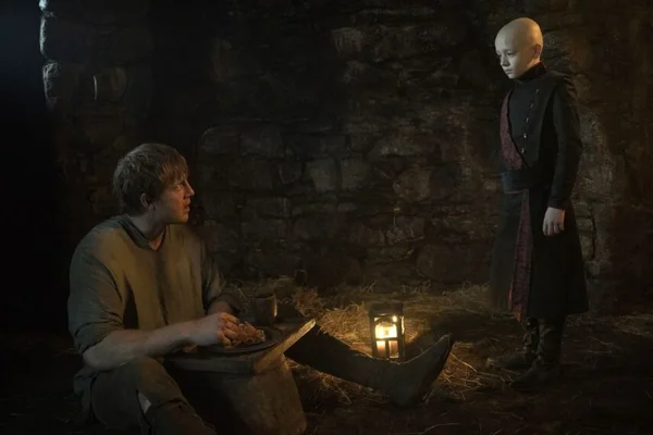 Peter Claffey as Dunk looking down in the rain at Dexter Sol Ansell as Egg in A Knight of the Seven Kingdoms