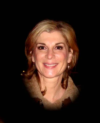 Michèle Laroque smiling at the press in January 2011.