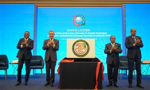 Men in suits clapping at a China-Africa diplomatic ceremony