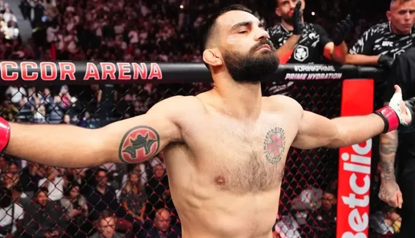 Benoit Saint Denis of France strikes Beneil Dariush of Iran in a lightweight fight during the UFC 322 event at Madison Square