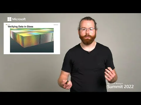 Un présentateur lors du Microsoft Research Summit 2022 explique la vérification des données dans le verre.