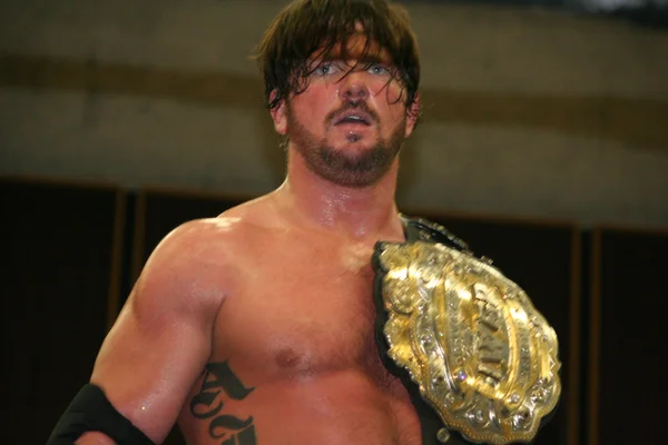 AJ Styles in action during a wrestling match.