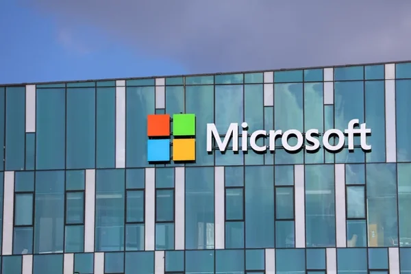 The Microsoft logo is displayed on a building, representing the company's $50 billion investment in Global South AI.