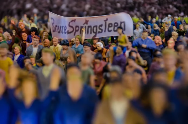 Bruce Springsteen performs live in East Berlin in 1988 with a massive crowd of fans visible in the background.
