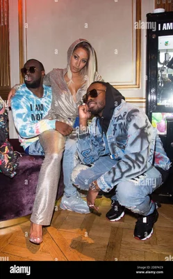 Gims, sa femme Demdem et son frère Dadju lors de la soirée de lancement de la capsule Elevenparis, le 11 avril 2019 à Paris.