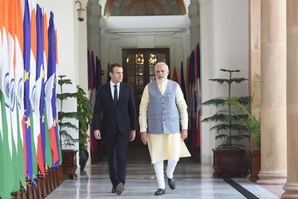 French President Emmanuel Macron gesturing while speaking at a technology summit.