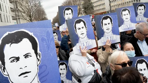 Manifestants brandissant des portraits de Quentin Deranque lors d'un rassemblement.