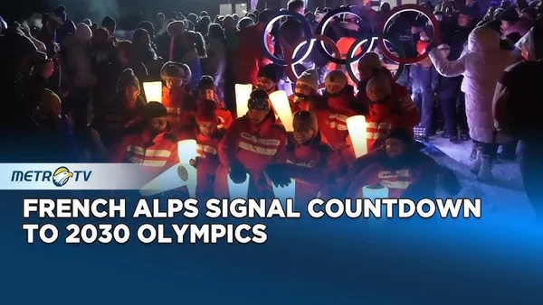 Winter sports athletes competing on snowy alpine course during a ski mountaineering event.