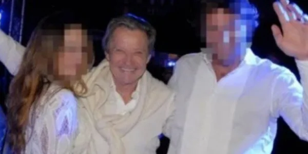 Jean-Luc Brunel, French modeling agent, posed with two other people in white outfits