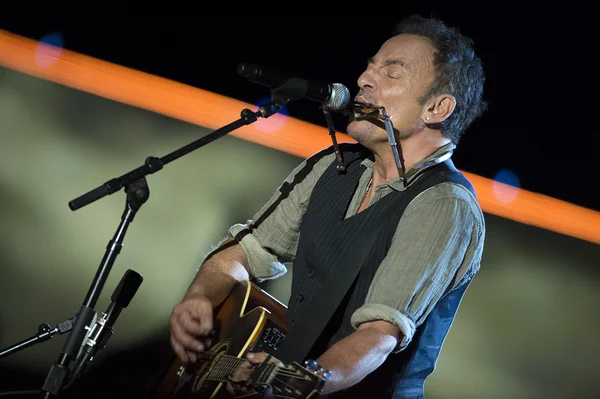 Bruce Springsteen performs live on stage holding a guitar at the Concert for Valor in Washington, D.C.