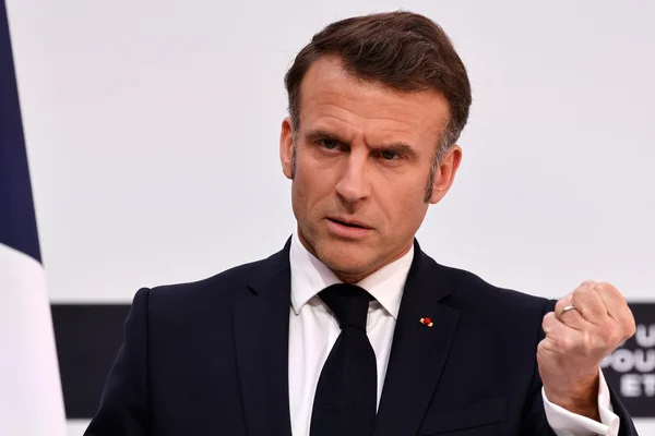 Emmanuel Macron lève le poing lors d'une intervention.
