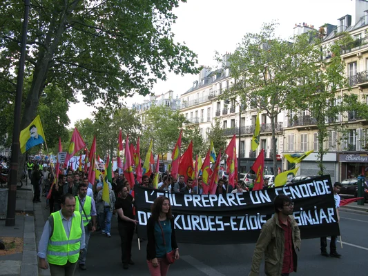 Groupe d'enfants posant devant une structure tentaculaire, témoignant de la vie après le génocide.