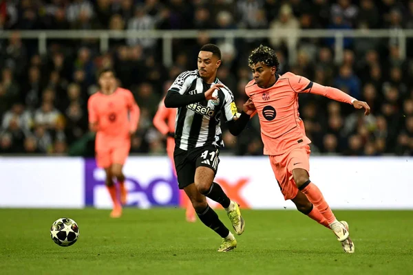 Action intense entre un joueur de Newcastle en maillot rayé noir et blanc et un joueur en maillot rose lors d'un match professionnel.