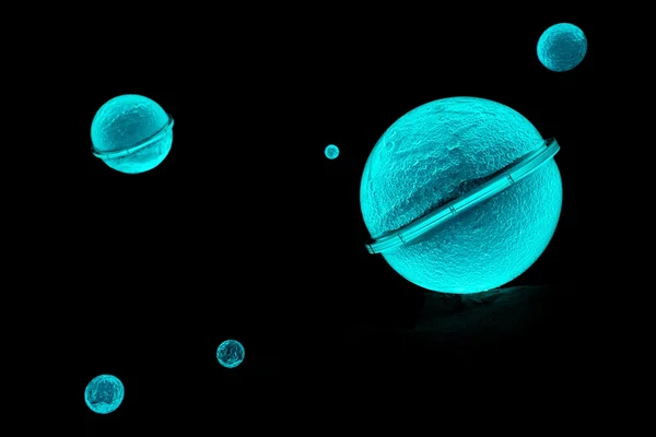 Sphères turquoise lumineuses rappelant des organismes marins, exposées lors des Extatiques.