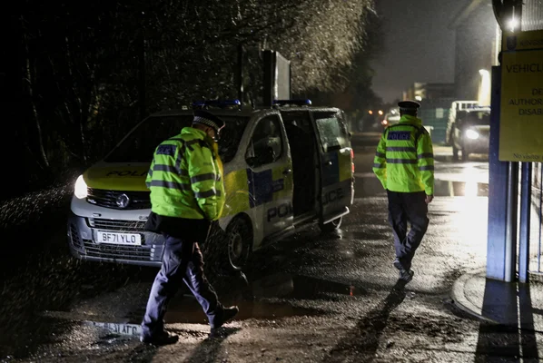 Un officier de la Metropolitan Police portant un gilet jaune et une casquette à carreaux.