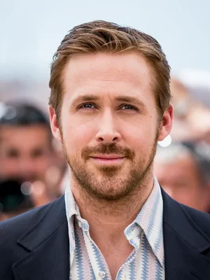 Portrait rapproché de l'acteur Ryan Gosling portant un blazer sombre et une chemise à motifs.