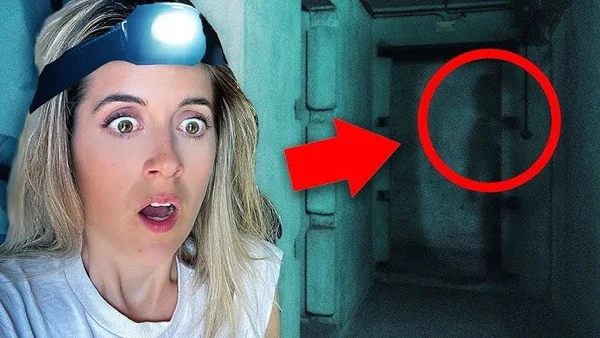 Personne blonde avec une lampe frontale pointant une porte sombre dans un couloir verdâtre.