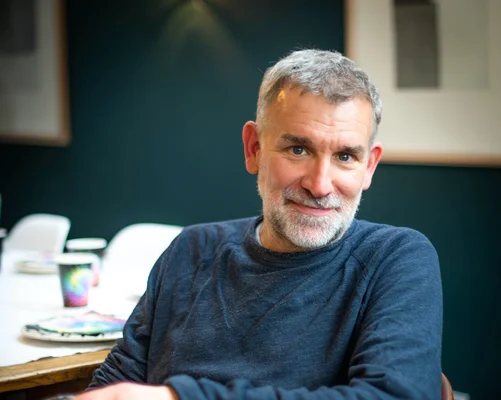 Des acteurs vêtus de costumes d'époque dans un décor rocheux et chaotique.