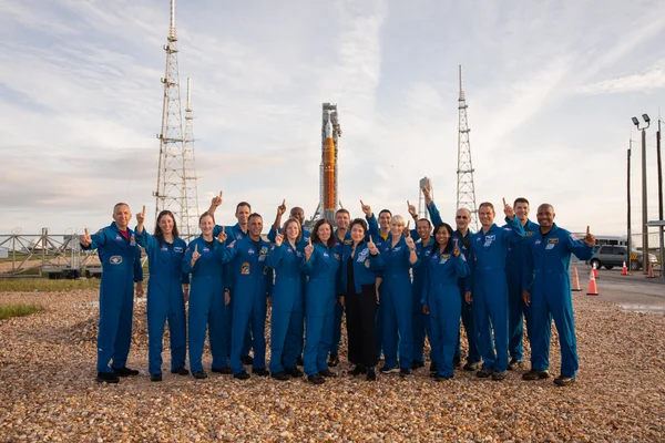 Des astronautes de la NASA et de l'ASC posent devant la fusèse SLS Artemis I le 28 août 2022.
