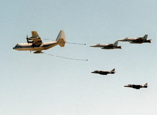 A U.S. Marine Corps Lockheed KC-130 Hercules attached to Marine Arial Refueler Transport Squadron VMGR-252 at Marine Corps Air Station Cherry Point, North Carolina (USA), refuels (left wing) two McDonnell Douglas F/A-18 Hornets, from MCAS Beaufort South Carolina, and two McDonnell Douglas AV-8B Harriers attached to Marine Attack Squadron VMA-231 in MCAS Cherry Point.
