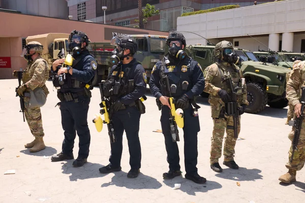 Groupe de forces de l'ordre et militaires en équipement tactique.