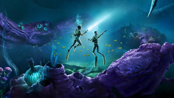 Deux plongeurs en combinaison nageant parmi des poissons jaunes et des coraux violets dans un décor aquatique lumineux.