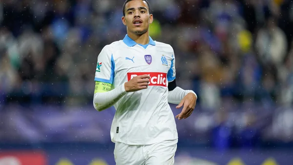 Greenwood en maillot olympien courant sur le terrain devant le public.