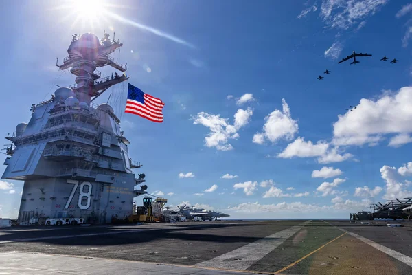 Le porte-avions américain USS Gerald R. Ford naviguant dans l'océan avec des avions en vol.