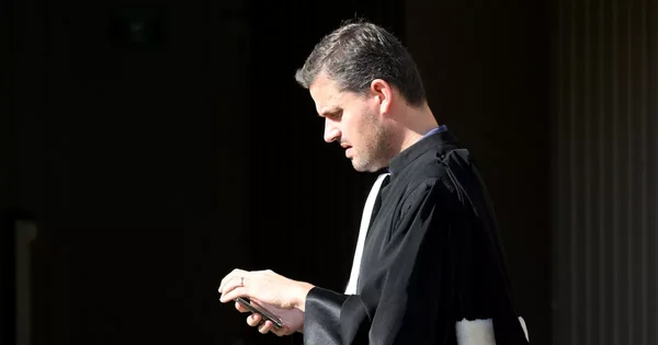 Un magistrat consulte son téléphone lors des procès des militants.