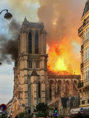 La cathédrale Notre-Dame de Paris en flammes, avec les pompiers luttant contre l'incendie qui consume la toiture.