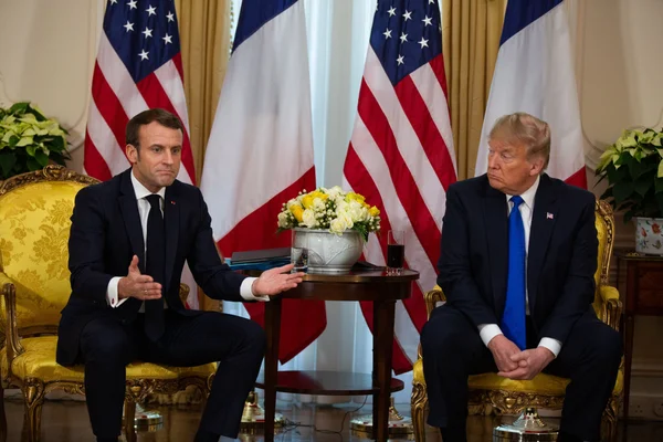 Emmanuel Macron et Donald Trump lors d'un entretien officiel dans un cadre prestigieux.