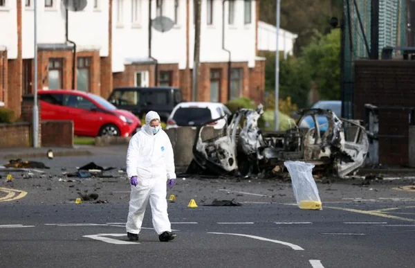 Investigation technique autour des restes d'une voiture-bombe ayant explosé en Irlande du Nord.