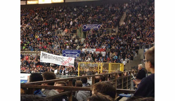 Une banderole 'MIGRANTS RAUS' déployée par des supporters dans les tribunes du stade de la Meinau.