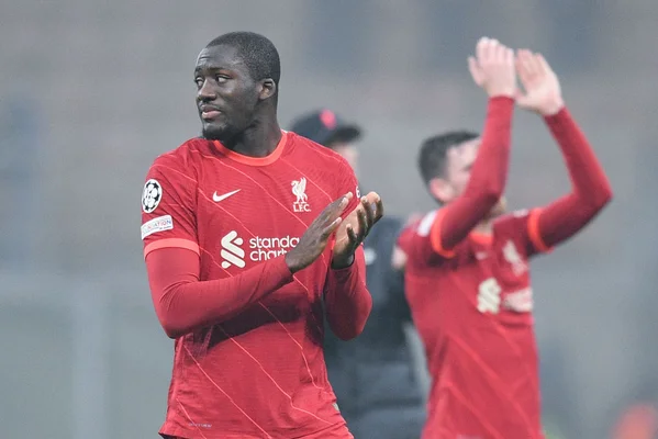 Deux joueurs de Liverpool interagissant sur le terrain après une action de jeu.