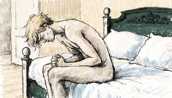 Homme nu assis sur le lit, le visage contracté par la douleur, se tenant le bas du ventre avec les mains