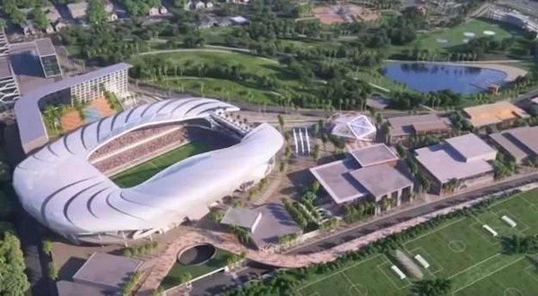 Le stade intégré harmonieusement dans un cadre de parc avec plans d'eau.