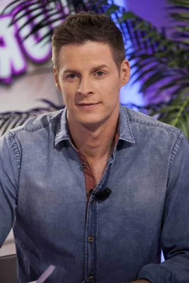 Matthieu Delormeau posant en chemise en jean bleue.