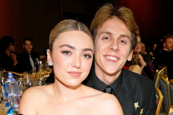 Peyton List et Jacob Bertrand posant ensemble et souriant lors d'un événement.