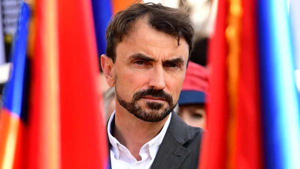 Grégory Doucet, maire de Lyon, en costume bleu lors d'une apparition en extérieur