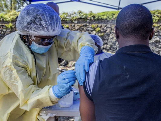 Un agent de santé vaccine un homme contre Ebola lors d'une campagne de vaccination en RDC.