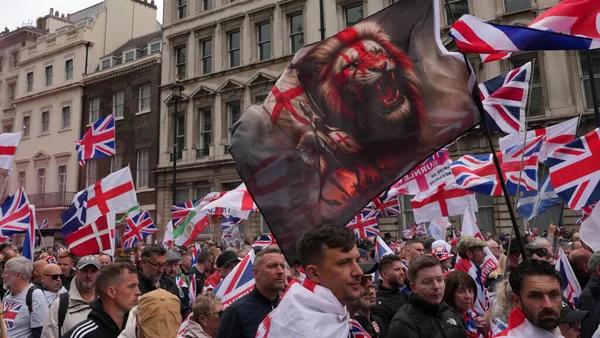 Manifestants d'extrême droite brandissant des drapeaux Union Jack et un étendard au lion lors d'une marche anti-immigration à Londres.