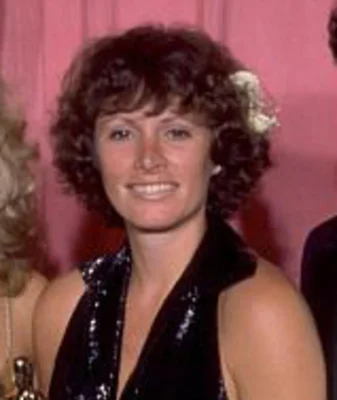 Marcia Lucas lors d'un événement, souriante dans une robe noire à sequins.