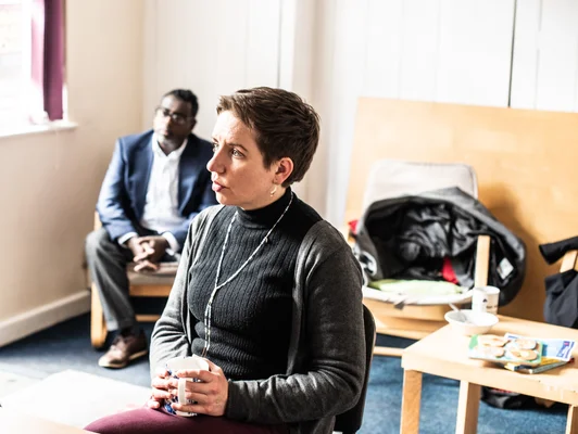 Carla Denyer et le conseiller Yassin Mohamud écoutant des résidents au Bristol Somali Resource Centre.