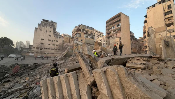 Des secouristes sur les décombres d'immeubles effondrés à Beyrouth après des frappes israéliennes.