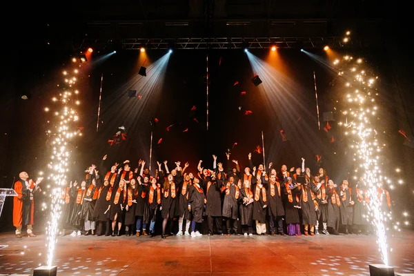 Diplômés de l'Institut Sociétés & Humanités de l'UPHF célébrant avec des cierges pyrotechniques lors de la remise des diplômes.