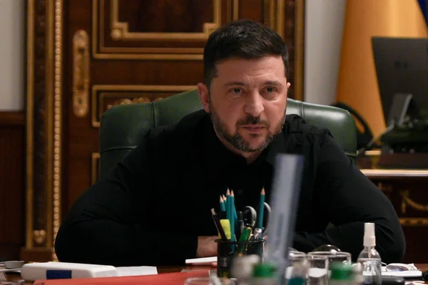 Volodymyr Zelensky assis à son bureau.