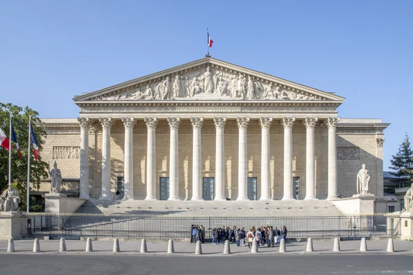 Le Palais Bourbon, siège de l'Assemblée nationale, sous un ciel bleu.