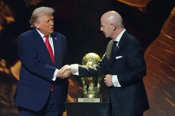 Donald Trump et Gianni Infantino avec un trophée personnalisé.