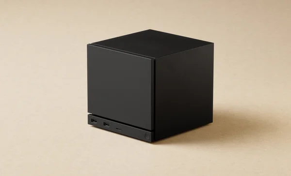 Boîtier cubique de la Steam Machine, présenté sur fond beige.
