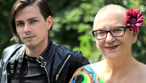 Desireless avec un fan ou un collaborateur, arborant une fleur rose derrière l'oreille.